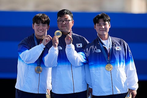 Archery men's team medal ceremony: Gold medal winners, South Korea's Je Deok Kim, left, Woojin Kim, center, Wooseok Lee